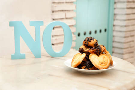 diet concept, plate of sweets on marble table, (letters word no), mediterranean house backgroundの写真素材