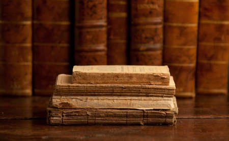 old books on old wooden shelf, with books in the backgroundの写真素材