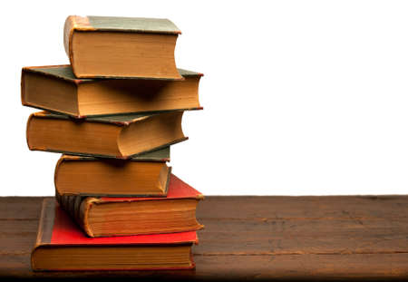 stack of old books on wooden table with white backgroundの写真素材