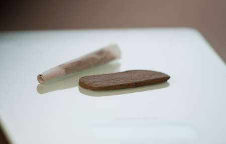Medical Hashish in the Kingdom of Morocco - CBD medical Moroccan cannabis hashish, with prepared cigar, on glassの写真素材