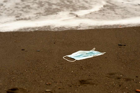 Waste during COVID-19. Scrapped to ocean coronavirus single-use face masks. Environmental and...