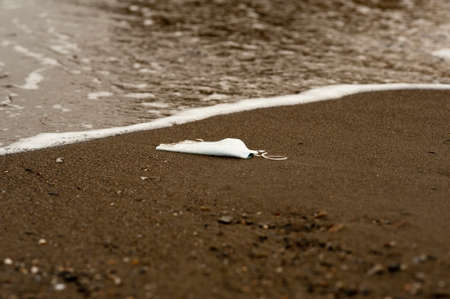 Waste during COVID-19. Scrapped to ocean coronavirus single-use face masks. Environmental and...