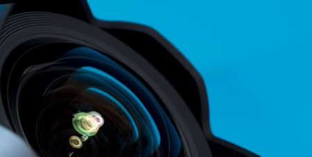 Optical partial sight. Reflection in the photo, camera on blue background.