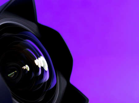 Optical partial view. Reflection in the photo, camera on purple background.