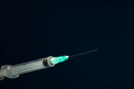 Closed syringe isolated on black backgroundの写真素材