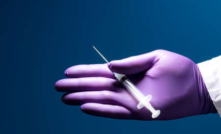 Syringe, medical injection in the hand, palm or fingers. Plastic vaccination kit with needle. Nurse...