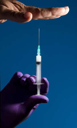 Man showing his palm refusing nurse injection or vaccination.の写真素材