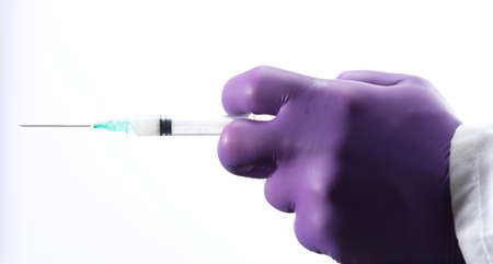 Doctor or nurse holding flu vaccine, syringe for measles injection preparations for baby and adult vaccination, medicine and drug concept, white backgroundの写真素材
