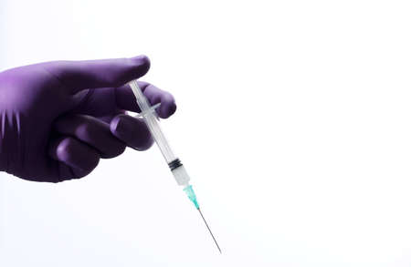 Doctor or nurse holding flu vaccine, syringe for measles injection preparations for baby and adult...