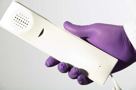health care concept, white phone, purple gloves, white background