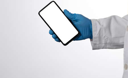 Doctor showing information on a smartphoneの写真素材