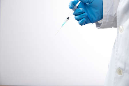 Doctor or nurse holding flu vaccine, syringe for measles injection preparations for baby and adult...