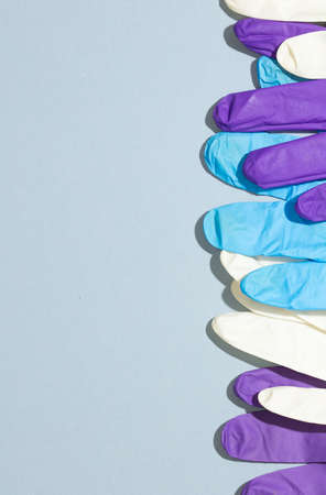 Colored gloves on plain backgroundの写真素材