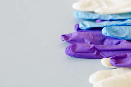 Colored gloves on plain backgroundの写真素材