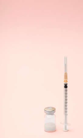 Syringe and ampules on pink background.Vaccination.の写真素材