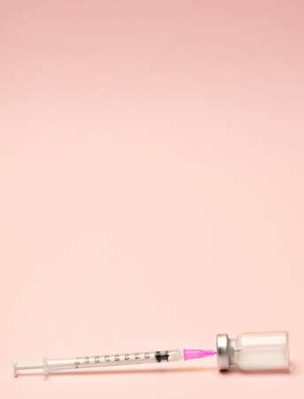 Syringe and ampules on pink background.Vaccination.の写真素材