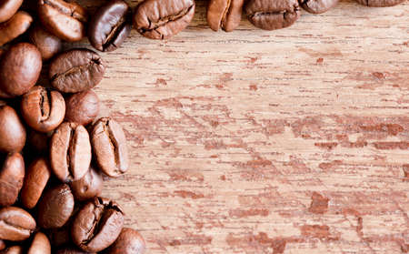 Close up view of roasted coffee beans, old wooden background