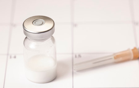 Vaccine vial, syringe, on top of calendar 2021の写真素材