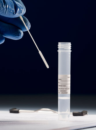 swab in the hand of a doctor (transport of viral PCR in laboratory), with transparent liquid,...