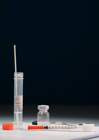 Transparent vial transport tube with swab inside, sticker for patient data, syringe and vaccine, on...