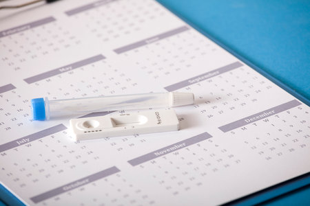 Rapid SARS-CoV-2 antigen test, with transport vial, on calendar 2022 blue backgroundの写真素材