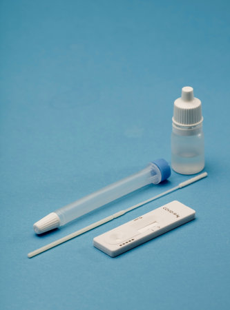 Rapid COVID-19 test. Serological detection of IgM and IgG antibodies against the new corona virus SARS-CoV-2 that causes Covid-19. Hand holds the test. Blue backgroundの写真素材