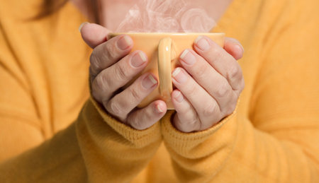 female hands with yellow cup and smoke, jersey (yellow)
