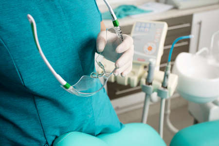 female dentist with protective glasses on hands, hospital backgroundの写真素材