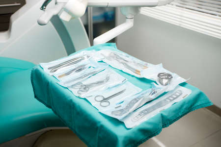 dentists work tray, individually packaged surgical materials, dental clinic backgroundの写真素材