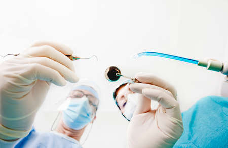 dental surgical material in the hands of dentist and nurse, white background, space for text.pace...