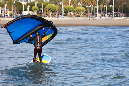 Man practicing with hydrofoil at sunset in the seaの写真素材