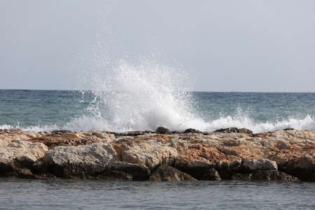Beautiful waves crashing on rocksの写真素材