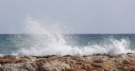 Beautiful waves crashing on rocksの写真素材
