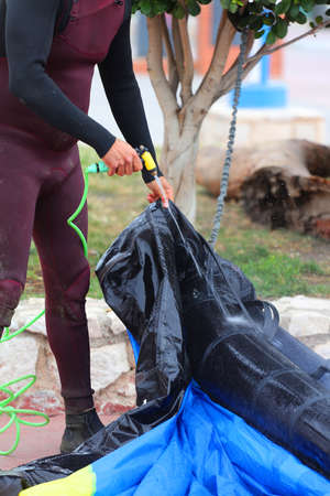 hydrofoil rider cleaning with water hose, kite windfoilの写真素材