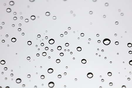 Water drops on white background texture. green background glass covered with water drops. bubbles in the waterの写真素材