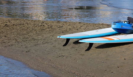 paddle boards, on the beach on the sand, at sunsetの写真素材