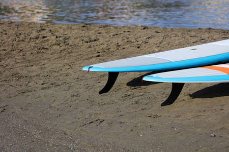 paddle boards, on the beach on the sand, at sunsetの写真素材