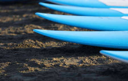 paddle boards, on the beach on the sand, at sunsetの写真素材