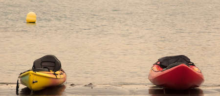canoes on the beach at sunset, space for textの写真素材