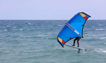 rider on a wind foil board, surf the wavesの写真素材