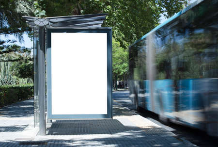White blank vertical billboard at the bus stop on the city street. In the background of buses and roads. Sketch. Poster on the street next to the road.の写真素材