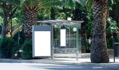 White blank vertical billboard at the bus stop on the city street. Sign on the street by the side of the road.の写真素材