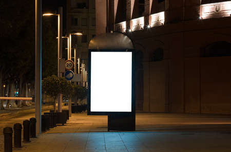 3d blank poster presentation for outdoor advertising, billboard with light in city centerの写真素材