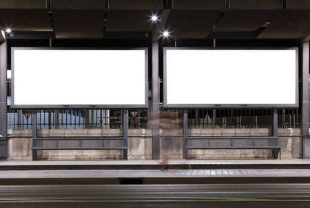 Two billboard with light in the center of the city at nightの写真素材