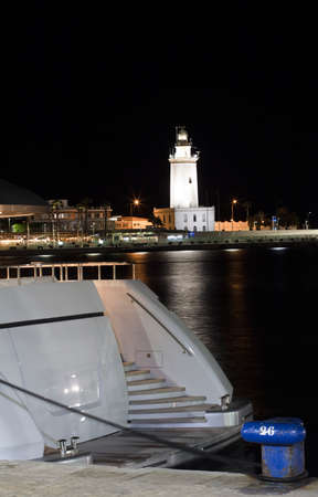 Yachts with Lighthouse of Malaga in the backgroundの写真素材