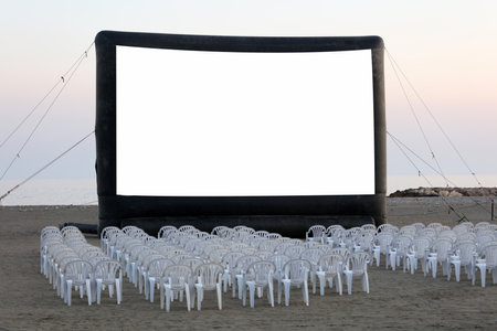 An open-air cinema on the beach at sunset. with chairs, no peopleの写真素材