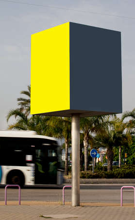 Template of two empty city billboards outdoors; mockup of informational posters in yellow and gray, in urban environments near the bus stop.の写真素材