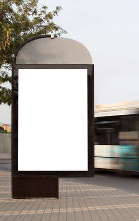 Vertical blank billboard on the city street with busの写真素材
