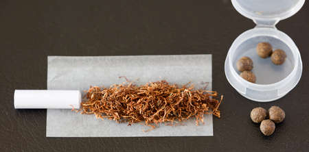 Preparations Hachi cigar, with nozzle, paper, tobacco, plastic container and hashishの写真素材