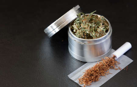 Marijuana in Grindr, with tobacco, smoking paper, and filter, black backgroundの写真素材